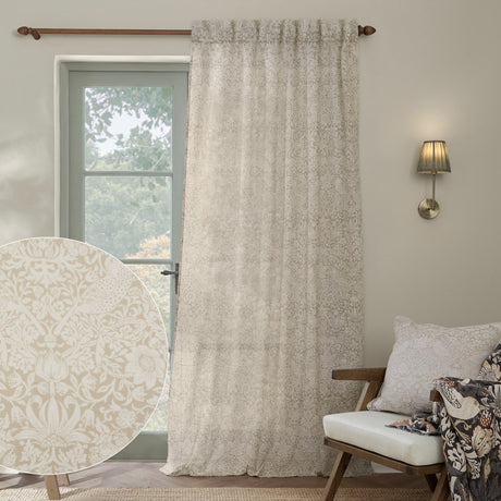 Strawberry Thief Floral Linen Curtain Panel in cream, hung by a window in a living room, with a fabric swatch inset showing the tonal bird and strawberry print.