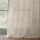 Strawberry Thief Floral Linen Curtain Panel in cream, hanging beside a window with a tonal bird and floral pattern on semi-sheer voile fabric.
