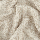 Strawberry Thief Floral Linen Curtain Panel draped in soft folds, showing a cream and sand tonal floral scroll pattern on semi-sheer open-weave voile fabric.