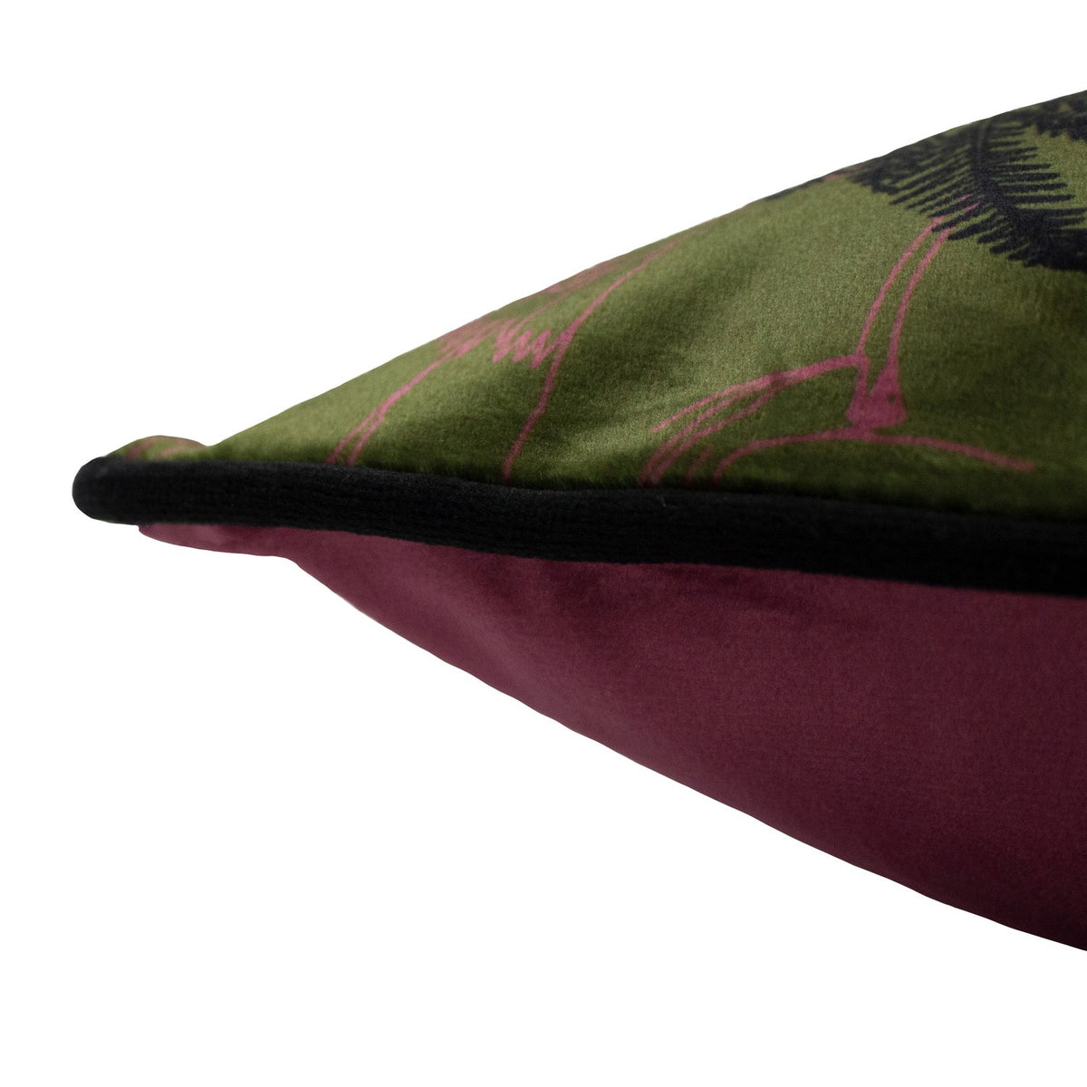 Corner detail of the Tropica Cheetah Animal Velvet Cushion in khaki, showing the printed green front with pink foliage outline, black piping, and plain deep red velvet reverse.