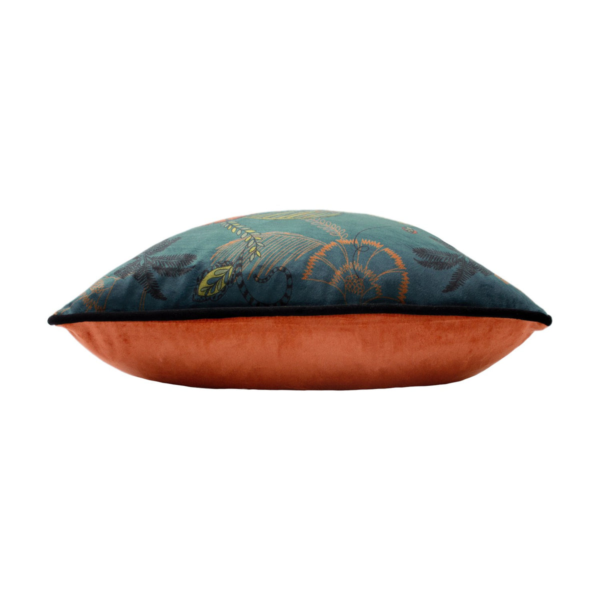 Side view of the Tropica Cheetah velvet cushion, showing teal floral-print front with black piping and plain rust-orange reverse, on a white background.