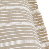 Close-up of the Tide Striped Cotton Cushion in natural beige with fine woven white stripes and a fringed edge along one side.