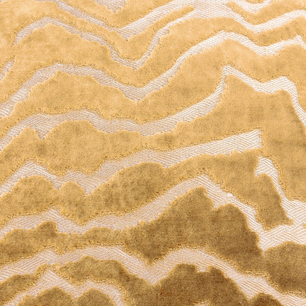 Tierra Abstract Velvet Cushion in brass gold, close-up of cut velvet pile forming a wandering chevron pattern against a flatter woven ground.