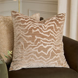 Tierra Abstract Velvet Cushion in taupe with cut-velvet zigzag pattern, styled on a dark brown sofa in a living room setting.