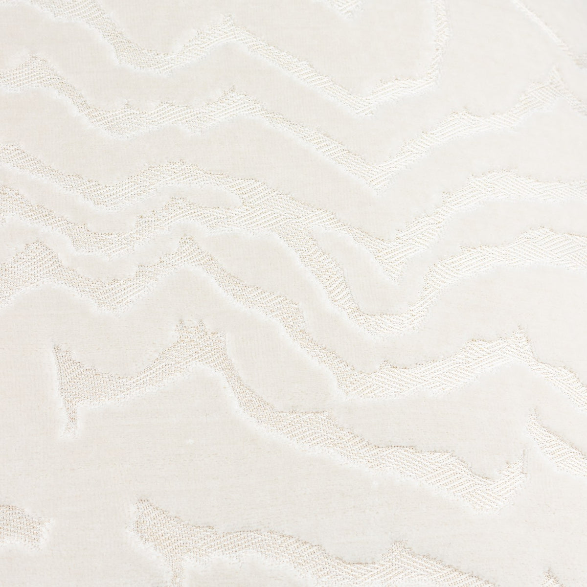 Tierra Abstract Velvet Cushion in white, close-up of raised cut-velvet ridges forming a jagged mountain-like pattern against the flatter woven ground.
