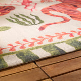 Close-up of the Tiger Dream Jungle Polyester Rug in multi, showing tiger, seaweed motifs and green-and-cream striped border, edge draped over a wooden surface.