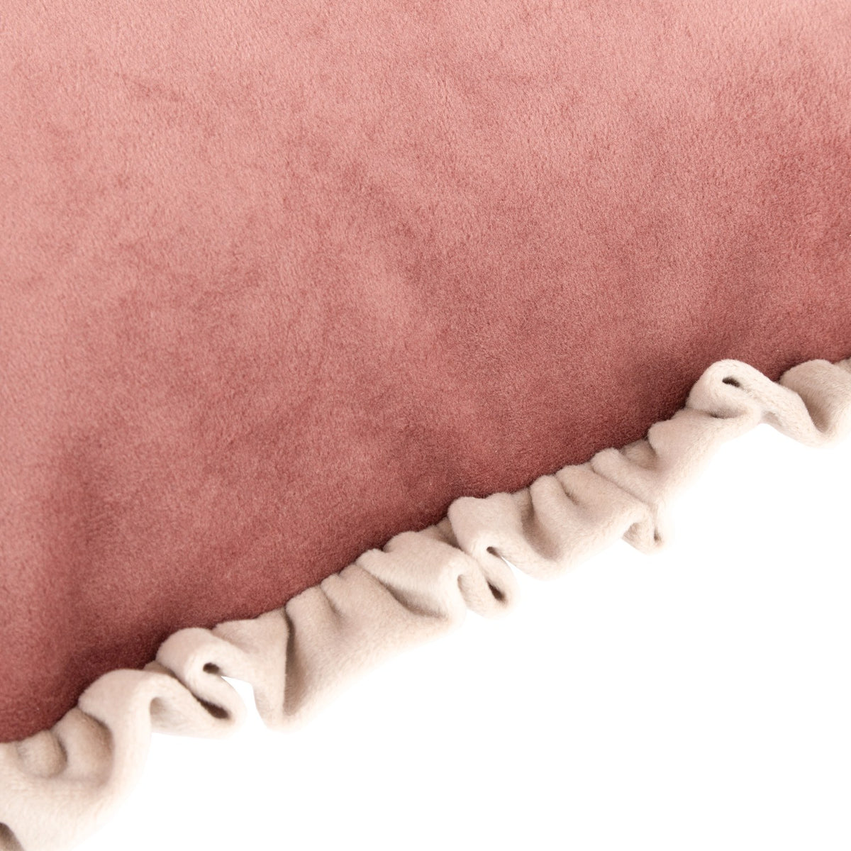 Close-up of the Tilly reversible velvet cushion showing the dusky pink face and cream ruffled edge trim detail.