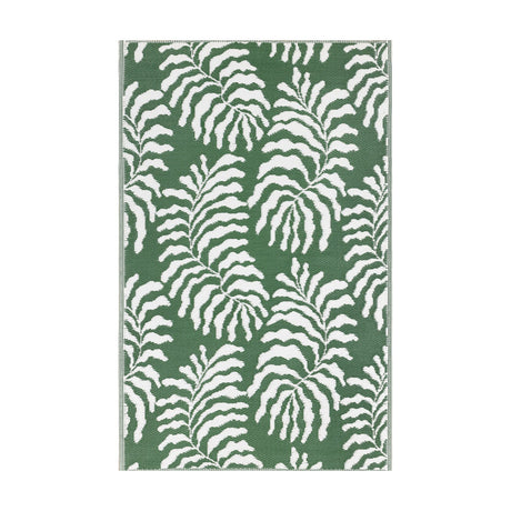 Tocorico Jacquard Jungle Rug in green and white, featuring a bold leaf pattern woven in polypropylene, shown flat on a plain background.
