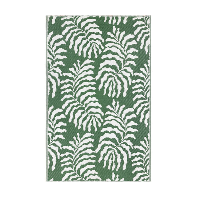 Tocorico Jacquard Jungle Rug in green and white, featuring a bold leaf pattern woven in polypropylene, shown flat on a plain background.