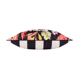 Side view of the Tropical Bloom Lost Reversible Polyester Cushion in black, showing tropical floral print on one edge and black-and-cream stripe on the other, against a white background.