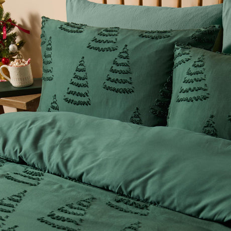 Green duvet cover set with tufted Christmas tree design in soft-touch polyester, styled on a bed with matching pillowcases in a festive bedroom setting.