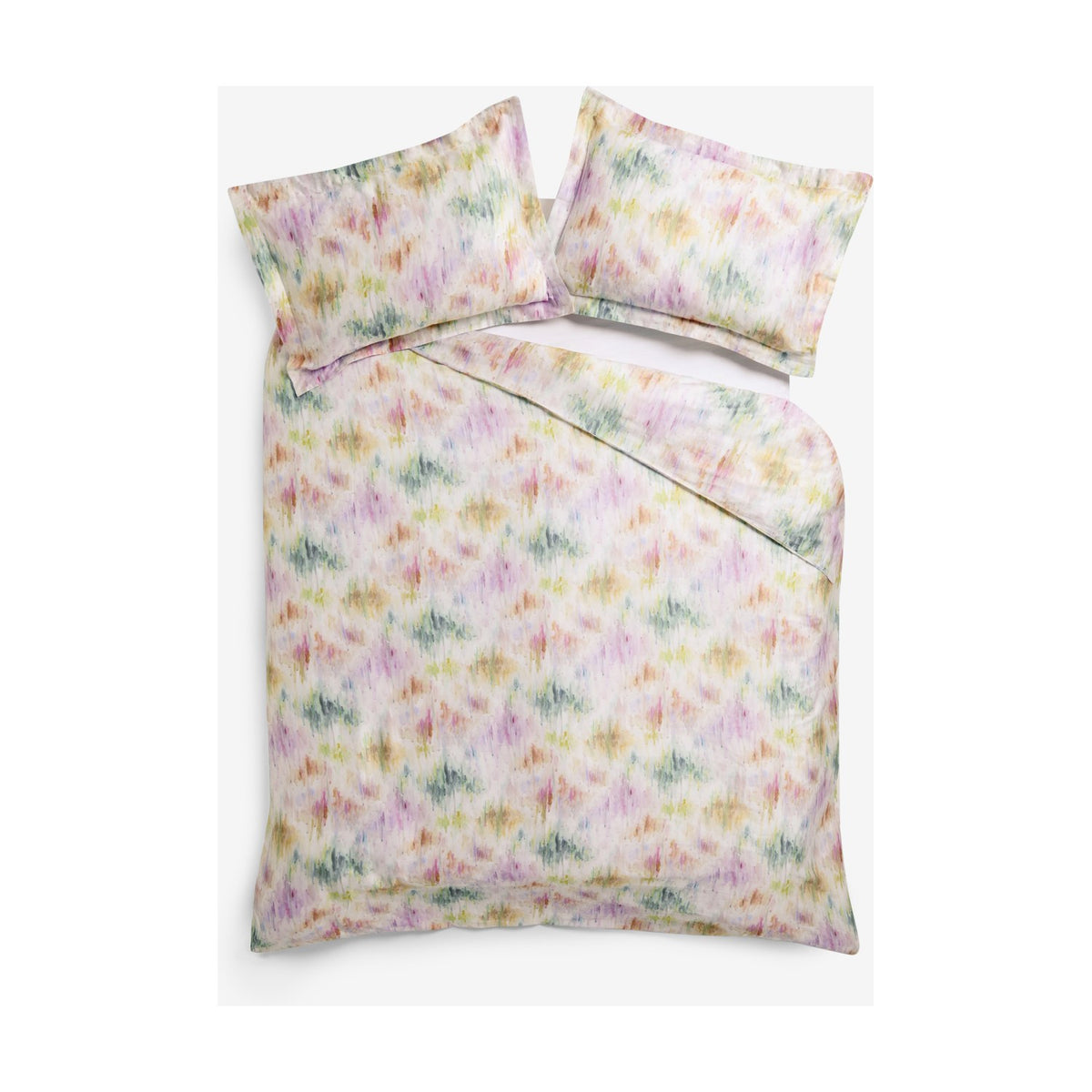 Trueno Cotton Abstract Duvet Cover Set in multicolour, with pink, purple, green and gold watercolour brushstrokes on cream cotton, styled with matching pillowcases on a white background.