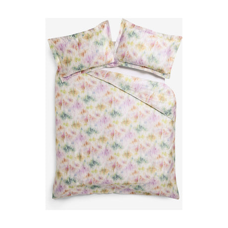 Trueno Cotton Abstract Duvet Cover Set in multicolour, with pink, purple, green and gold watercolour brushstrokes on cream cotton, styled with matching pillowcases on a white background.