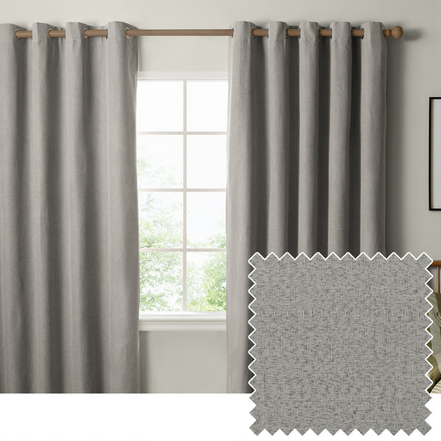 The Ultimate Blackout Plain Woven Eyelet Curtains in grey hang from a wooden pole either side of a window, with a woven fabric swatch shown inset.