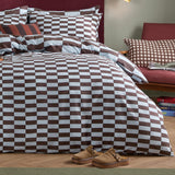 The Ultimate Checkerboard Check Duvet Cover Set in Blueberry Muffin dresses a bed with brown and white check-print cotton-blend bedding, matching pillowcases, in a bedroom setting.