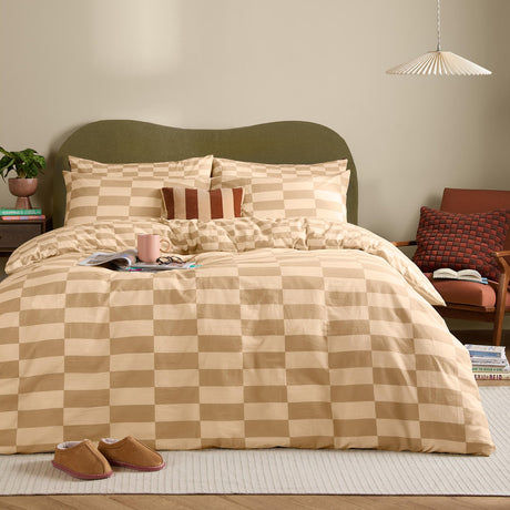 The Ultimate Checkerboard Check Duvet Cover Set in Caramel Latte, styled on a bed with matching pillowcases and a striped cushion in a modern bedroom.