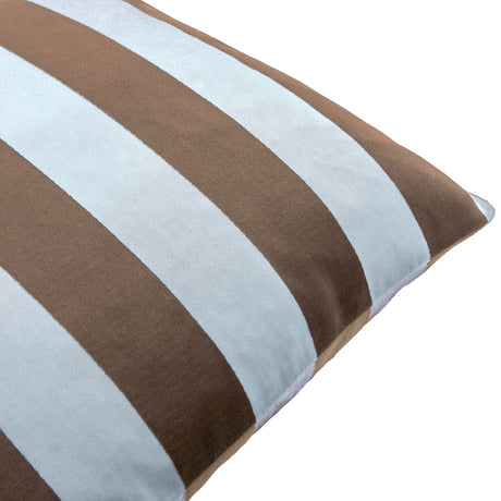 Close-up of The Ultimate Stripe Jacquard Velvet Cushion in bold brown and pale blue vertical stripes, showing the velvet texture and corner piping against a white background.