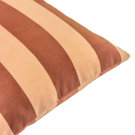 Close-up of The Ultimate Stripe Jacquard Velvet Cushion in Pumpkin Spice, showing wide woven vertical stripes in peachy caramel and terracotta rust velvet against a white background.