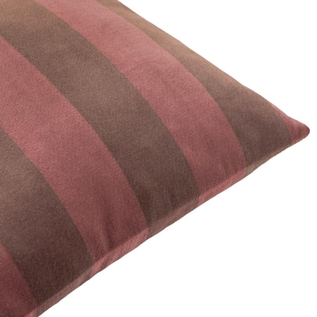 Close-up of The Ultimate Stripe Jacquard Velvet Cushion in red velvet, showing bold vertical stripes in dusky rose and deep cocoa brown with a piped edge, on a white background.