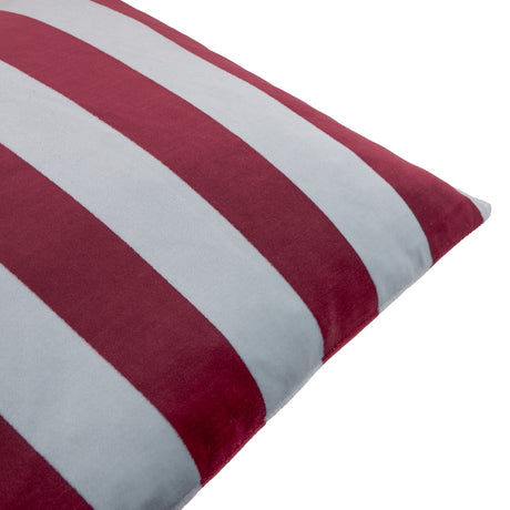 Close-up of The Ultimate Stripe Jacquard Velvet Cushion in Sangria Sky, showing bold vertical stripes in deep red and pale blue-grey velvet with a piped edge, on a white background.