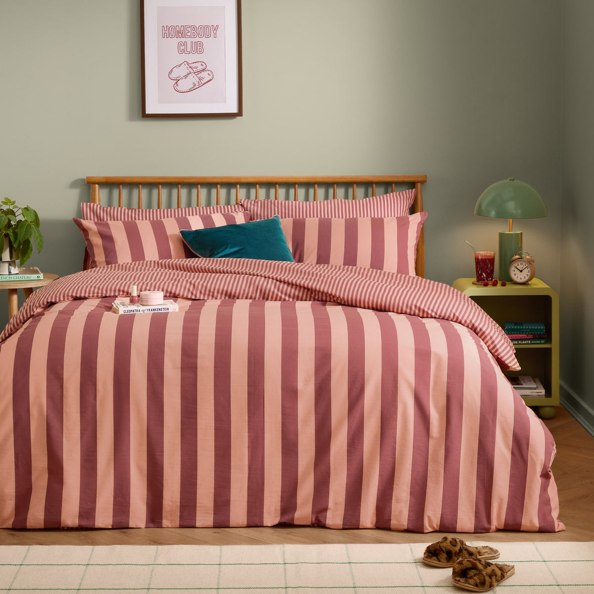The Ultimate Stripe Reversible Duvet Cover Set in Raspberry Smoothie, wide pink and blush stripes on a bed with matching pillowcases in a bedroom setting.