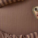 The Ultimate Stripe Cotton Blend Fitted Sheet in Chocolate Truffle, shown on a bed with matching pillowcase, featuring a tonal caramel and cocoa brown stripe pattern.
