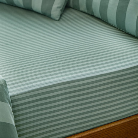 The Ultimate Stripe Cotton Blend Fitted Sheet in peppermint, shown fitted on a bed with matching striped pillows, showing the tonal stripe pattern and fabric texture.