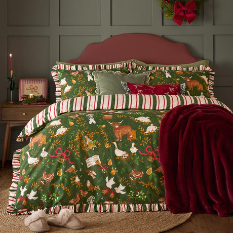 Twelve Days Frill Cotton Striped Duvet Cover Set in green, dressed on a bed with festive animal print, striped ruffle trim, matching pillowcases and a red faux fur throw in a bedroom setting.