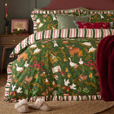 Green Twelve Days Frill Cotton Striped Duvet Cover Set on a bed, featuring highland cows, geese, hens and doves among gold foliage, with red and cream striped frill edging.