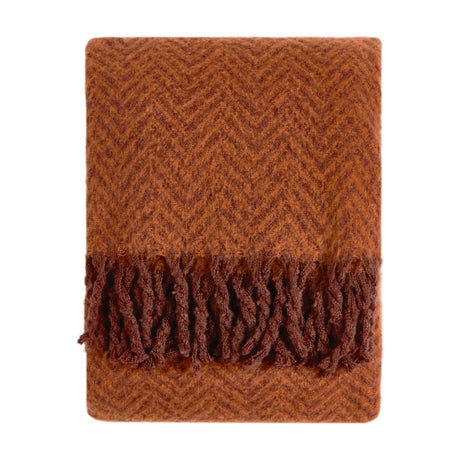 Tweedie Herringbone Polyester Throw in cinnamon, folded flat with a woven herringbone pattern and brushed fringe on each end, shown on a plain white background.