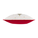Side view of the Twinkling Tree Velvet Linen Cushion showing natural linen-look front with embroidered gold star detail, red pom-pom trim, and red velvet back, on a white background.