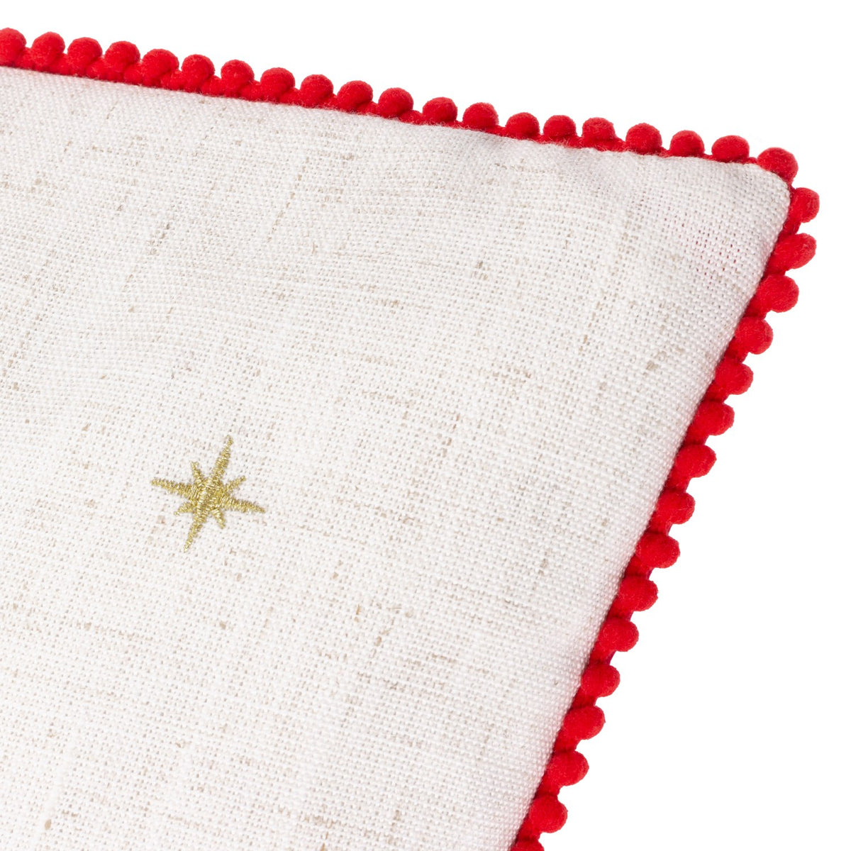 Close-up of the Twinkling Tree Velvet Linen Cushion in natural linen-look fabric with a gold embroidered star and red pom-pom trim edging, shown on a white background.