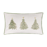 Rectangular cream velvet cushion embroidered with three green Christmas trees with red berries and gold stars, edged in green pompom trim, shown on a white background.