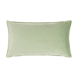Rectangular sage green velvet cushion with pompom ric rac trim edging, shown reverse side on a plain white background.