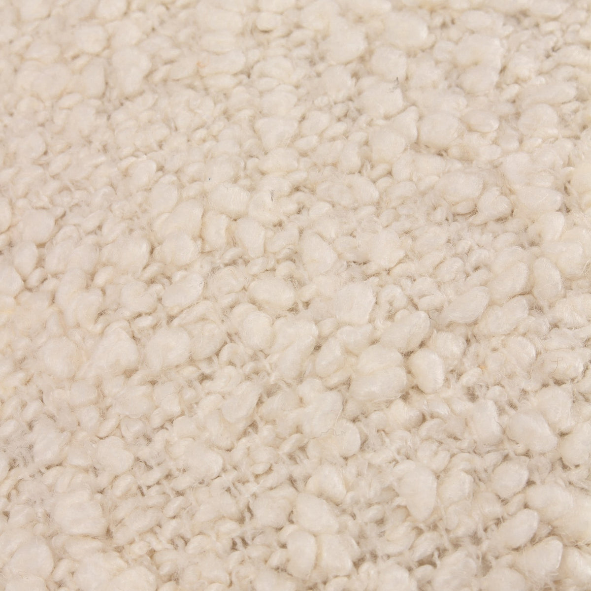 Close-up of the Ulsmere Wool Cotton Cushion in ecru, showing its looped boucle texture in pale cream tones.