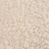 Close-up of the Ulsmere Wool Cotton Cushion in ecru, showing its looped boucle texture in pale cream tones.