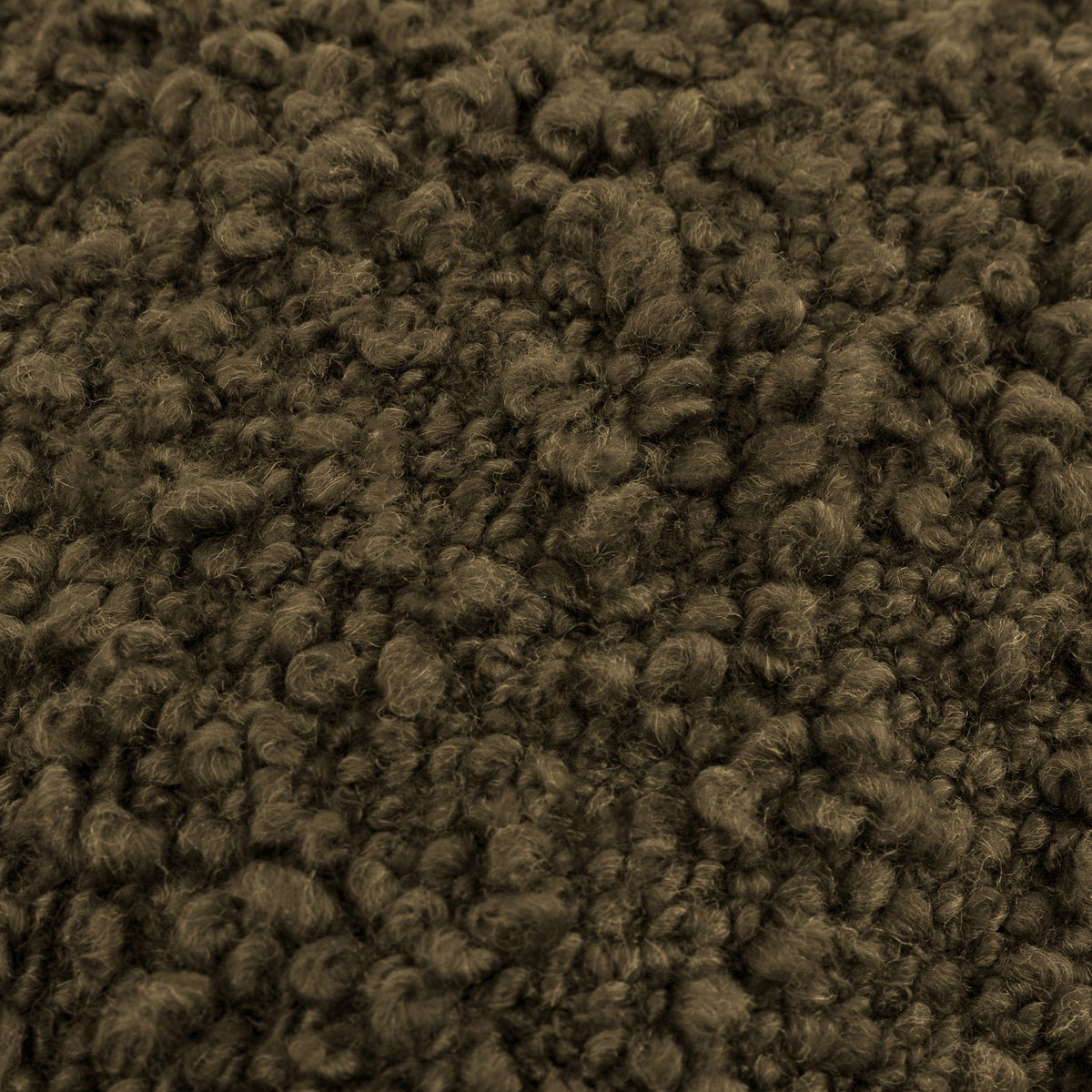 Close-up of the Ulsmere Wool Cotton Cushion in Lichen, showing its oversized bouclé fabric with looped, nubbly texture in a deep olive-green tone.