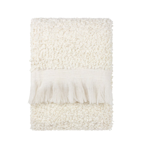 Folded Ulsmere Reversible Wool Throw in ecru, showing oversized bouclé texture with a smooth fringed border, on a plain white background.
