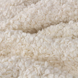 Close-up of the Ulsmere Reversible Wool Throw in ecru, showing an oversized bouclé looped texture in soft cream fabric.