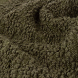 Close-up of the Ulsmere Reversible Wool Throw in lichen green, showing its deep, looped oversized bouclé texture in fine detail.