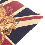 Close-up of the Union Jack Jacquard Cotton Cushion corner, showing woven red, navy and cream stripes with a gold heraldic lion crest and "Honor" scroll detail on a white background.