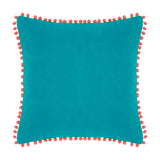 Square teal velvet cotton cushion with coral pompom trim around all edges, shown on a plain white background.