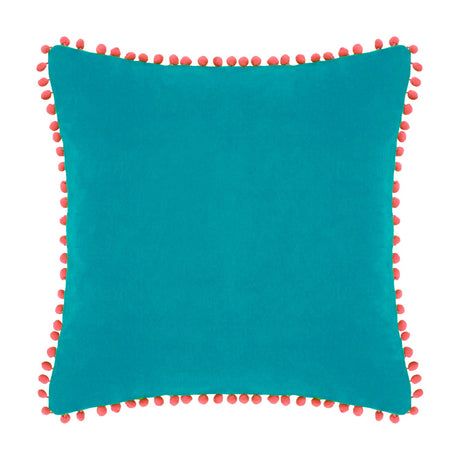 Square teal velvet cotton cushion with coral pompom trim around all edges, shown on a plain white background.