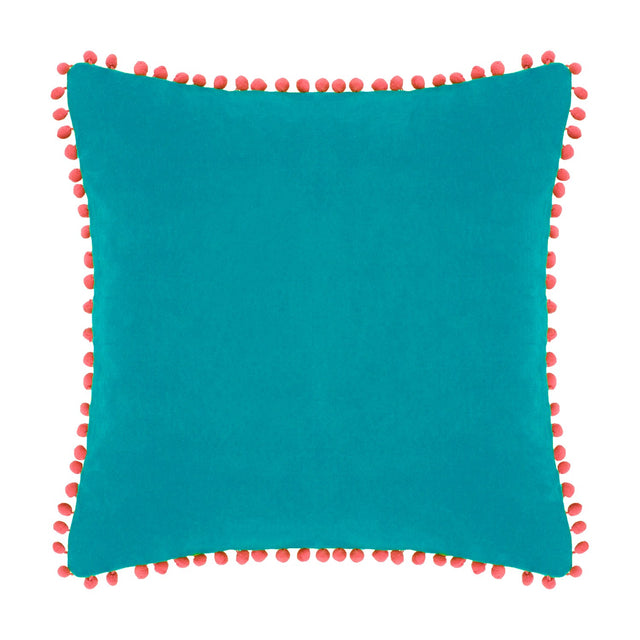 Square teal velvet cotton cushion with coral pompom trim around all edges, shown on a plain white background.
