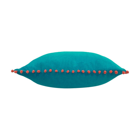Velvet Pompom Plain Cotton Cushion in teal, shown lying flat with coral pompom trim along the seam, plain white background.