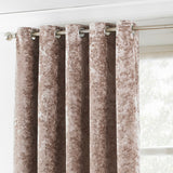 Verona Velvet Fully Lined Eyelet Curtains in Oyster, crushed velvet fabric with mottled shimmer, silver eyelet heading on a metal pole beside a window.