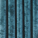 Close-up of Verona fully lined eyelet curtains in teal crushed velvet, showing deep folds with light catching the pile's shifting texture.