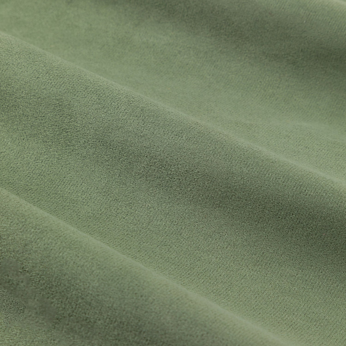 Close-up of the Verso Reversible Eyelet Curtains in green, showing the soft suede-effect fabric with a gentle napped texture and folds.