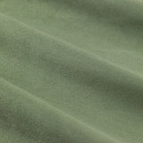 Close-up of the Verso Reversible Eyelet Curtains in green, showing the soft suede-effect fabric with a gentle napped texture and folds.