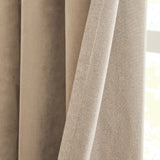Close-up of Verso reversible eyelet curtains in mocha, showing the smooth suede-effect face and the textured woven reverse side with a folded edge seam.